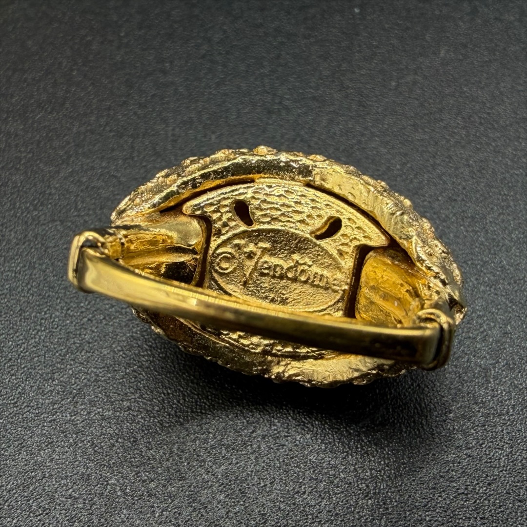 Vendome gold-tone textured ring mark.