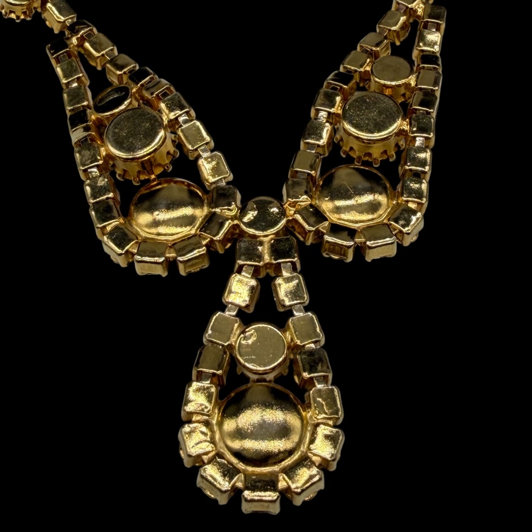 Vintage gold-tone black rhinestone necklace up close.